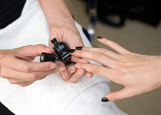 Modelo fazendo a unha antes do desfile da Chanel, com o Le Vernis 219 Black Satin - Foto: Divulgação/ Vincent Lappartient