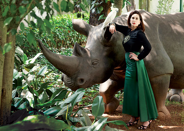 Claudia usa blusa Lanvin, saia Huis Clos, bracelete e anel Ara Vartanian e sandálias Chanel, em frente ao rinoceronte assinado por Valdo Keppern que ganhou da amiga Carol Andraus - Foto: Jorge Lepesteur/Harper's Bazaar