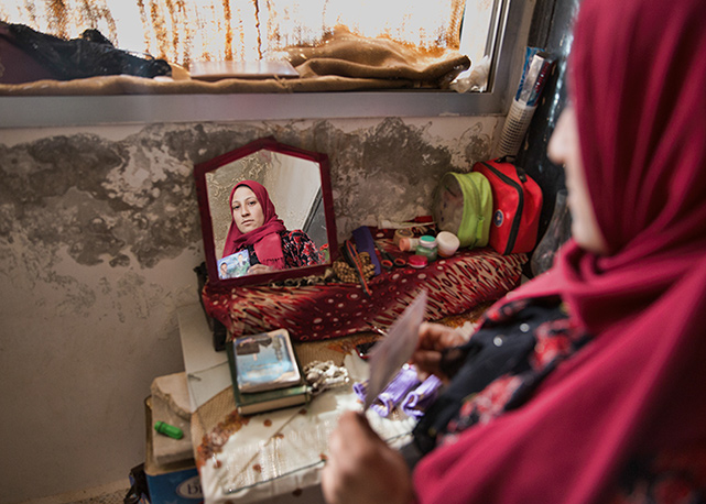 A woman holds a picture of her dead husband - Foto: Gabriel Chaim